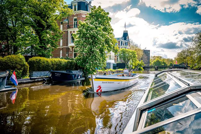 Open boat sailing in summer in Amsterdam