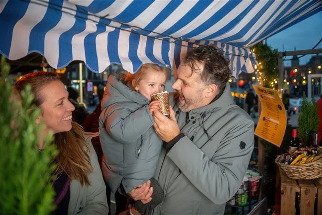 A little girl enjoying a hot chocolate at a Canal tours Amsterdam Pier